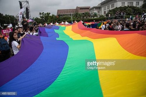 TAIPEI, TAIWAN - 2015/10/31: The rainbow flag, a symbol of gay rights, leads off the annual LGBT pride march. Upwards of 60 000 people took to the streets of Taipei for the annual Pride march, the largest such event in Asia. Taiwan is often said to be the likeliest Asian nation to legalize gay marriage. (Photo by Craig Ferguson/LightRocket via Getty Images)