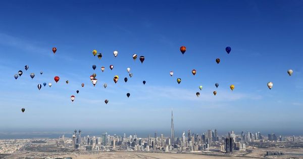 Hot air balloons fly over Dubai during the World Air Games 2015, held under the rules of the Federation Aeronautique Internationale (FAI) as part of the "Dubai International Balloon Fiesta" event, United Arab Emirates December 9, 2015. REUTERS/Karim Sahib/Pool