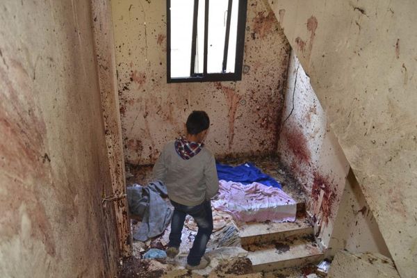 A boy walks down a staircase with splashed blood on the walls of a staircase caused by an explosion inside a building in Deir Ammar town, northeast from the city of Tripoli, Lebanon December 5, 2015. A suspected Islamist militant and two members of his family were killed in northern Lebanon on Saturday, after the man blew himself up during an army raid on his home, security and medical sources said. The raid took place in the town of Deir Ammar, northeast of the city of Tripoli. The explosion killed the wife and mother of the suspect, who was named as Mohammed Hamzeh, a security source said. At least 10 others were wounded, including four security personnel. A security source said Hamzeh was part of a group that had pledged allegiance to Islamic State. REUTERS/Fathi Al Masri