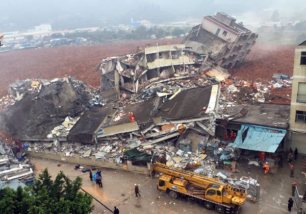 Rescuers search for survivors amongst collapsed buildings after a landslide in Shenzhen, in south China's Guangdong province, Sunday Dec. 20, 2015. The landslide collapsed and buried buildings at and around an industrial park in the southern Chinese city of Shenzhen on Sunday authorities reported. (Chinatopix via AP) CHINA OUT